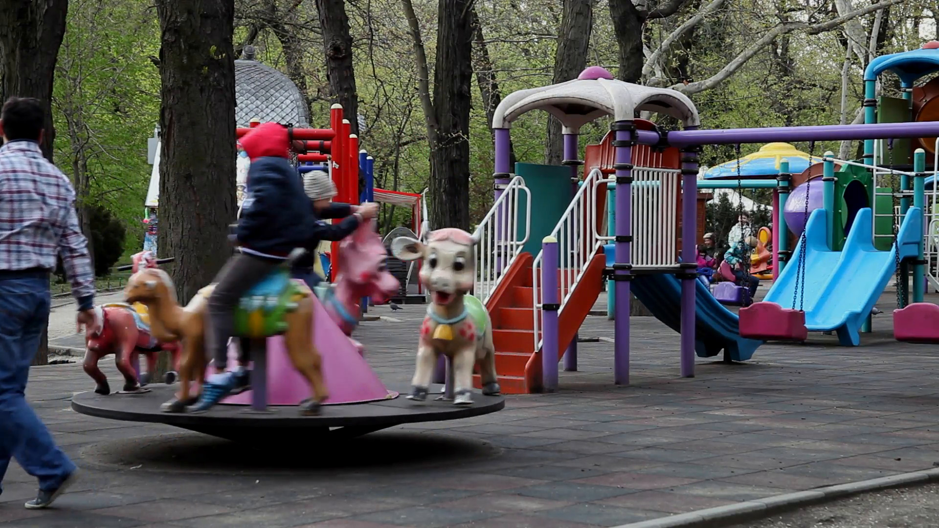 1920x1080 Children's playground, happy kids riding Merry go round, carousel, park;  Editorial use only Stock Video Footage - VideoBlocks