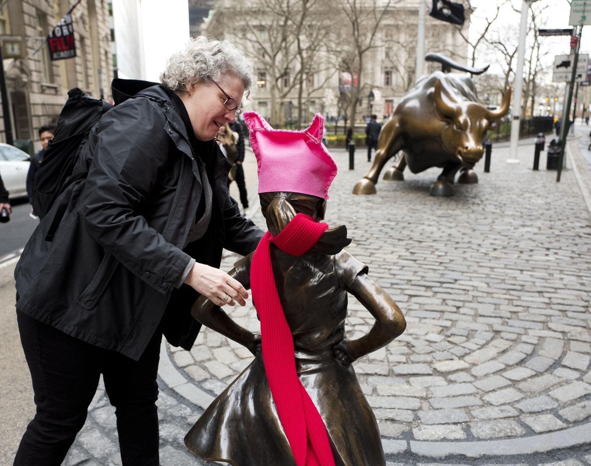 1920x1515 ... a woman places a red scarf on a statue of a fearless girl facing the  wall; wall street bronze bull ...