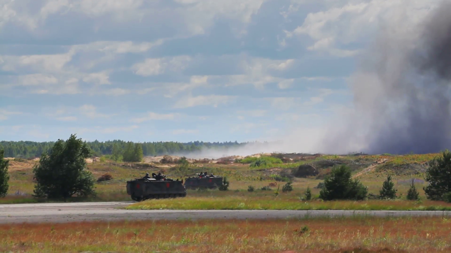 1920x1080 GAIZIUNAI, LITHUANIA - JUNE 17, 2014: Military vehicle against smoke  background in the field, explosion, NATO exercise Saber Strike 2014 -  editorial use ...
