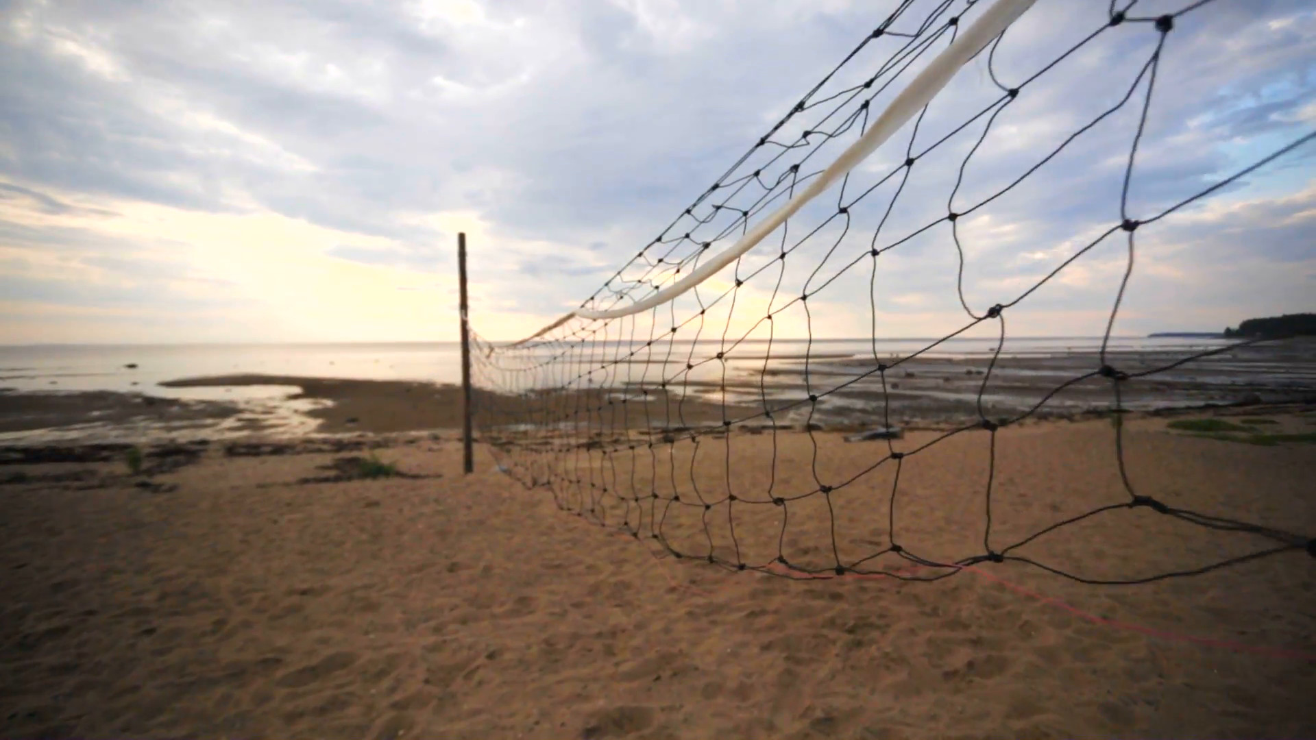 1920x1080 A closeup of volleyball court divider net on the beach.