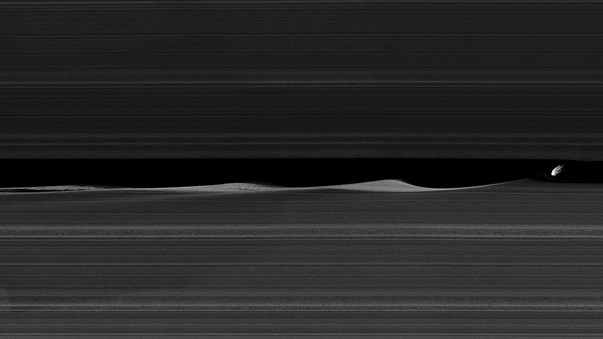 1920x1080 Daphnis, one of Saturn's ring-embedded moons, is featured this view, kicking