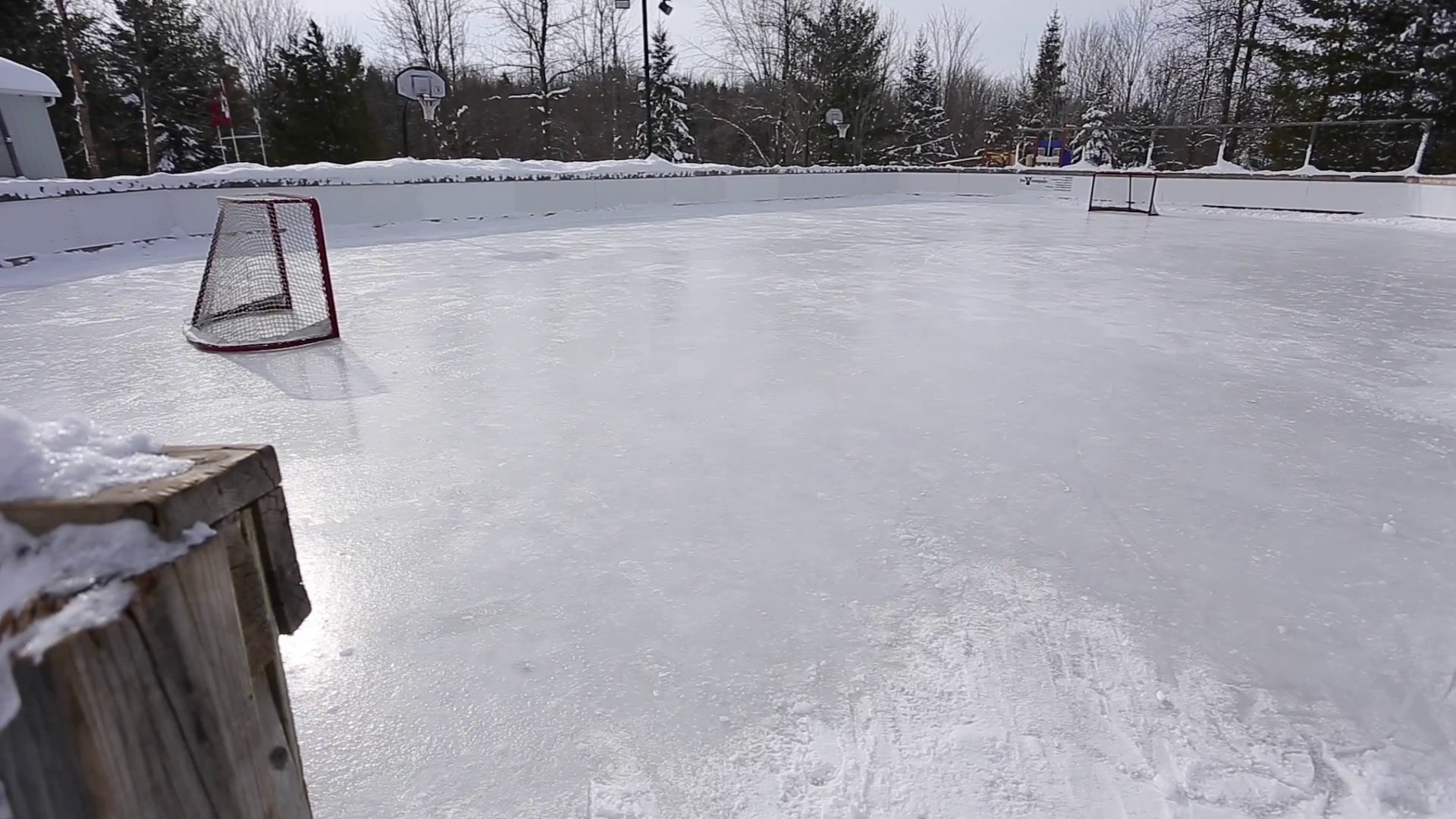 1920x1080 outdoor hockey rink with snowy forest background upward tilt reveal Stock  Video Footage - VideoBlocks