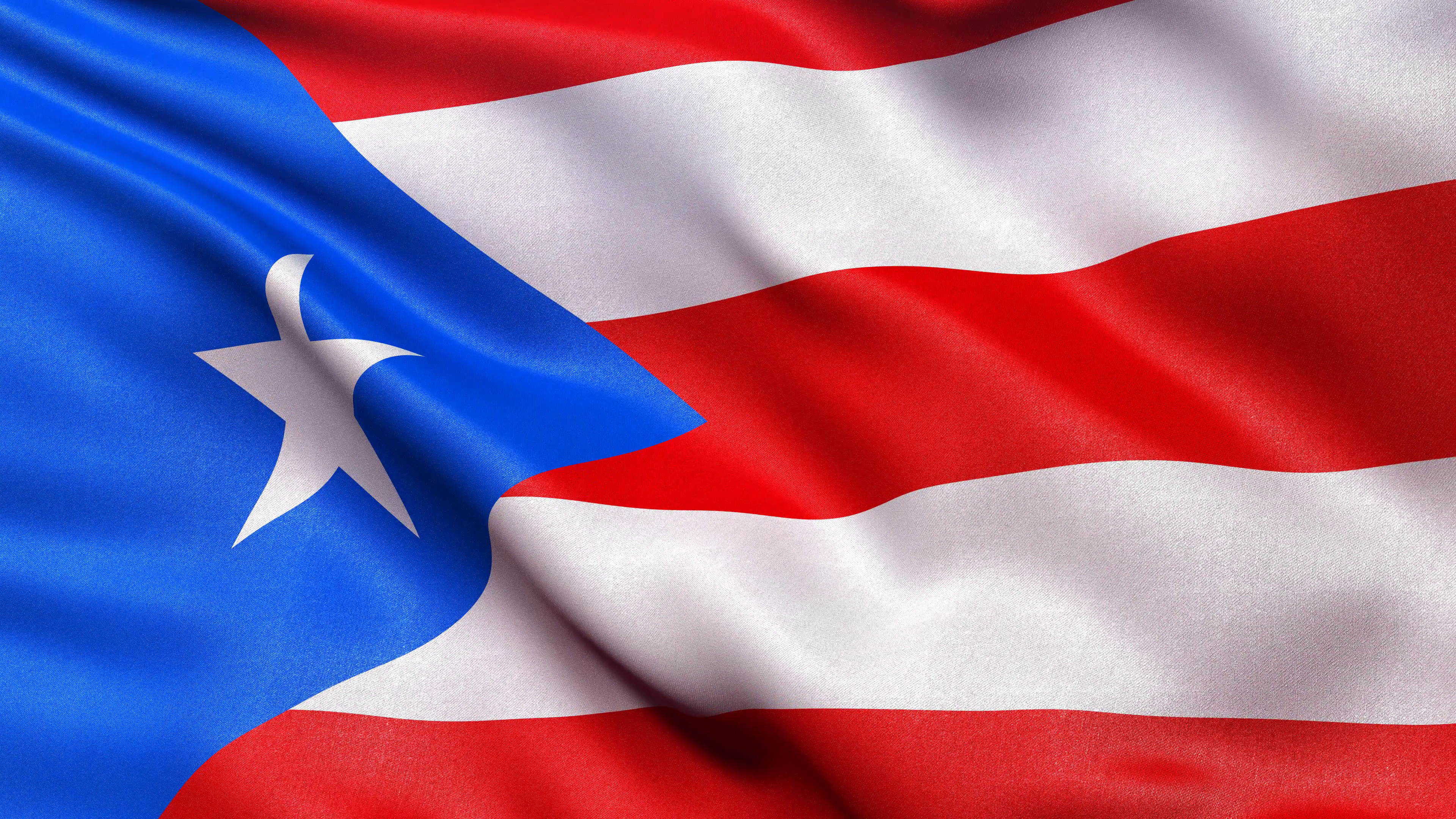 3840x2160 Realistic flag of Puerto Rico waving in the wind. Seamless loop with highly  detailed fabric texture. Loop ready in 4K resolution.