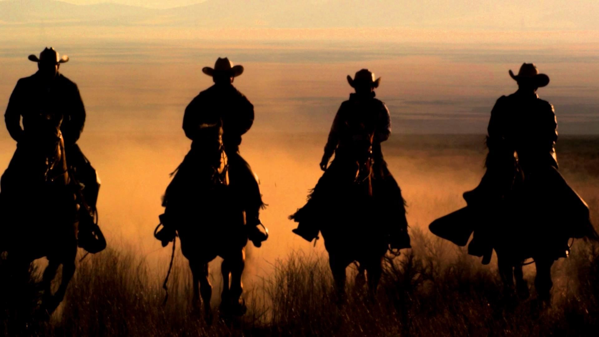 1920x1080 Slow-Motion-Panning-Shot-Of-Four-Cowboys-Riding-