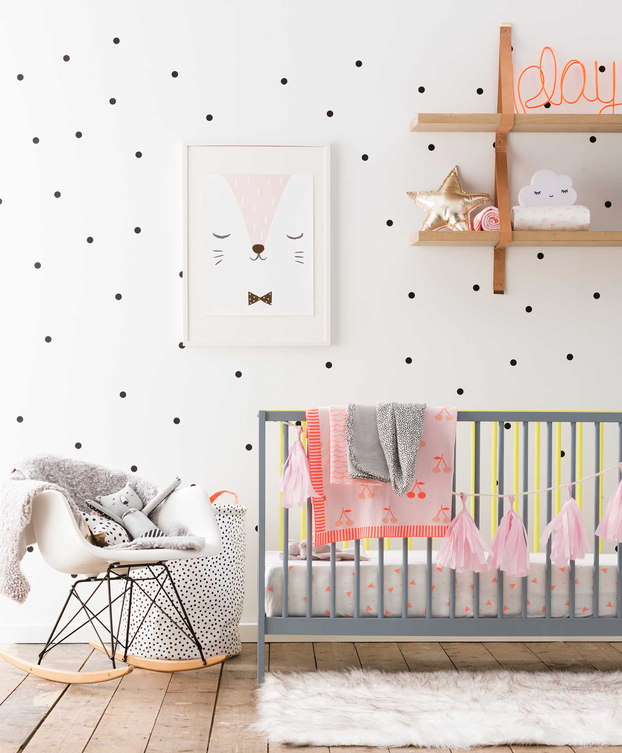 1996x2416 Small black polka dots on the nursery wall, grey crib, white Eames rocking  chair and light brown wooden shelves