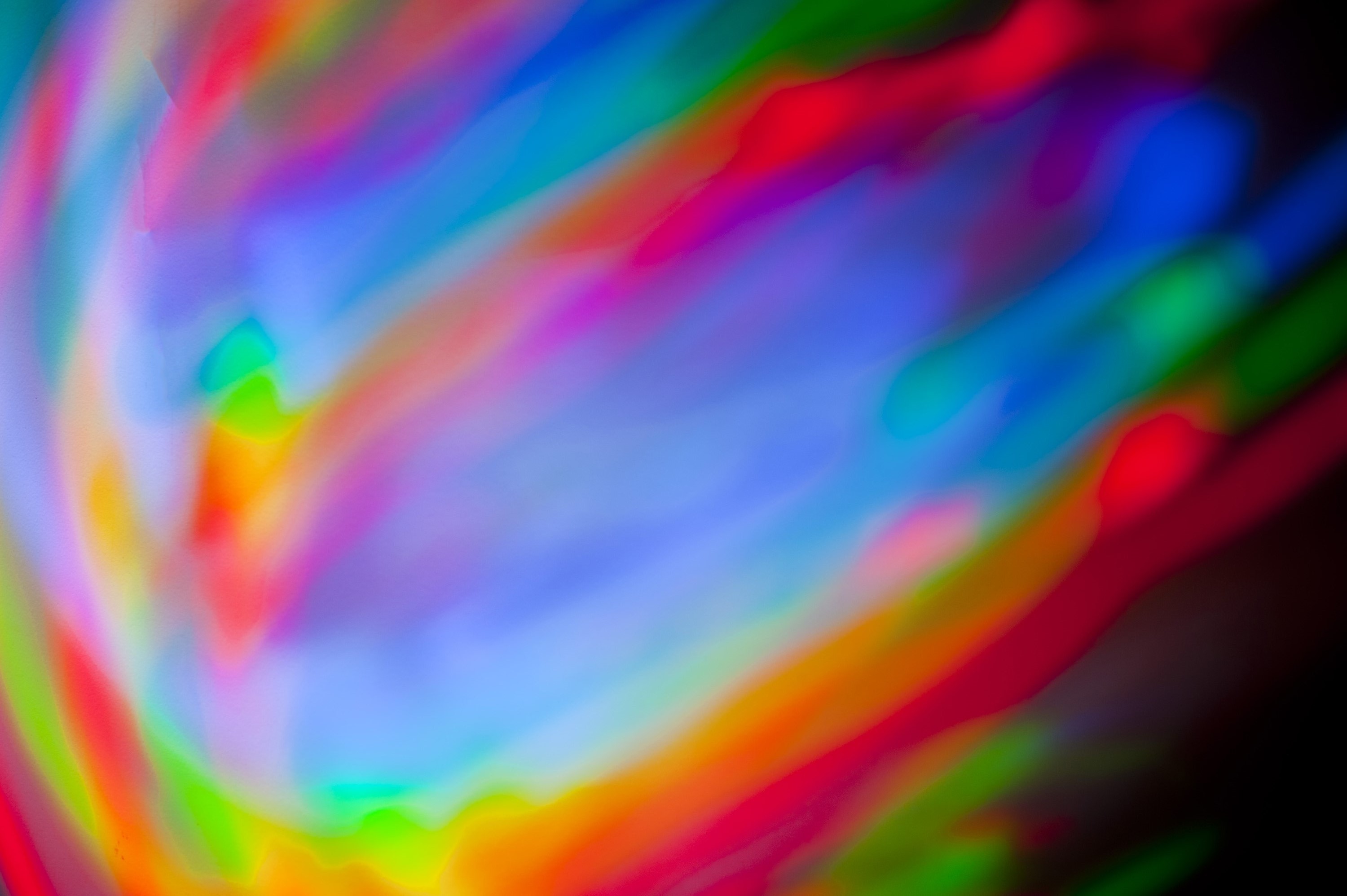3000x1996 a creative background of mixing red green and blue vivid coloured strokes  of light