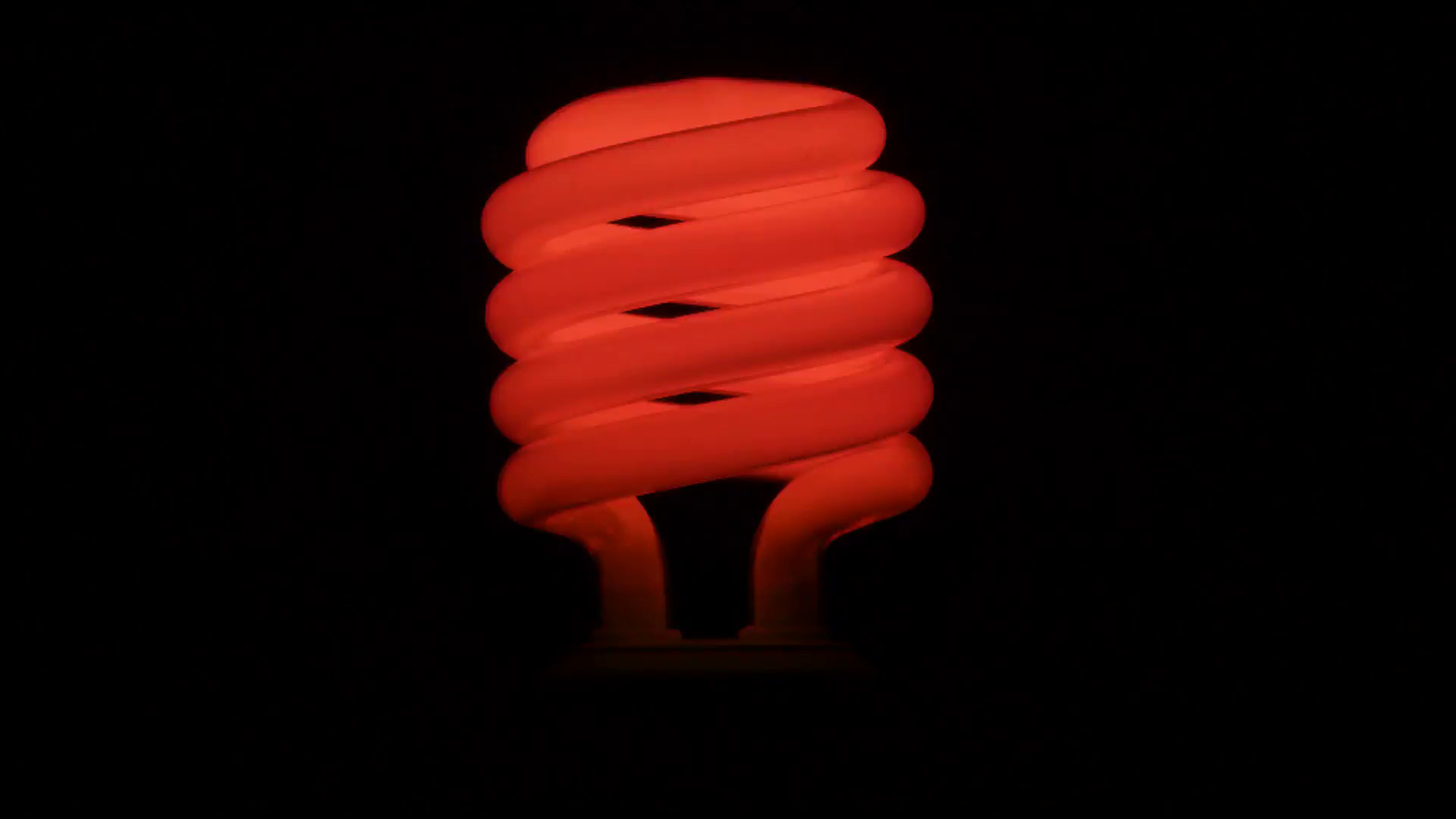 1920x1080 Flickering red fluorescent light bulb in dark room against .