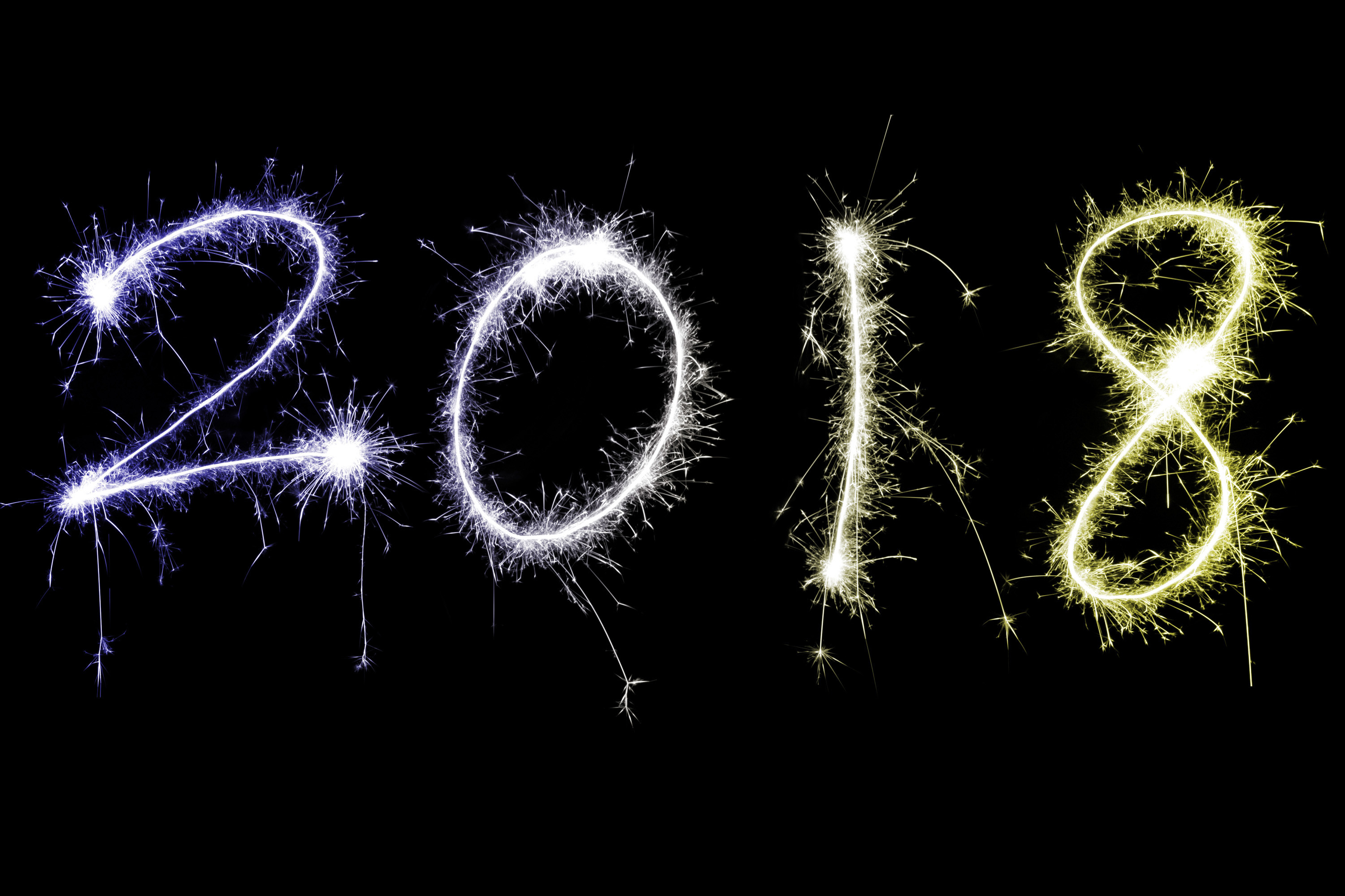 3000x2000 Fiery colorful multicolored 2018 New Year date with sparkling trails over a  black background with copy