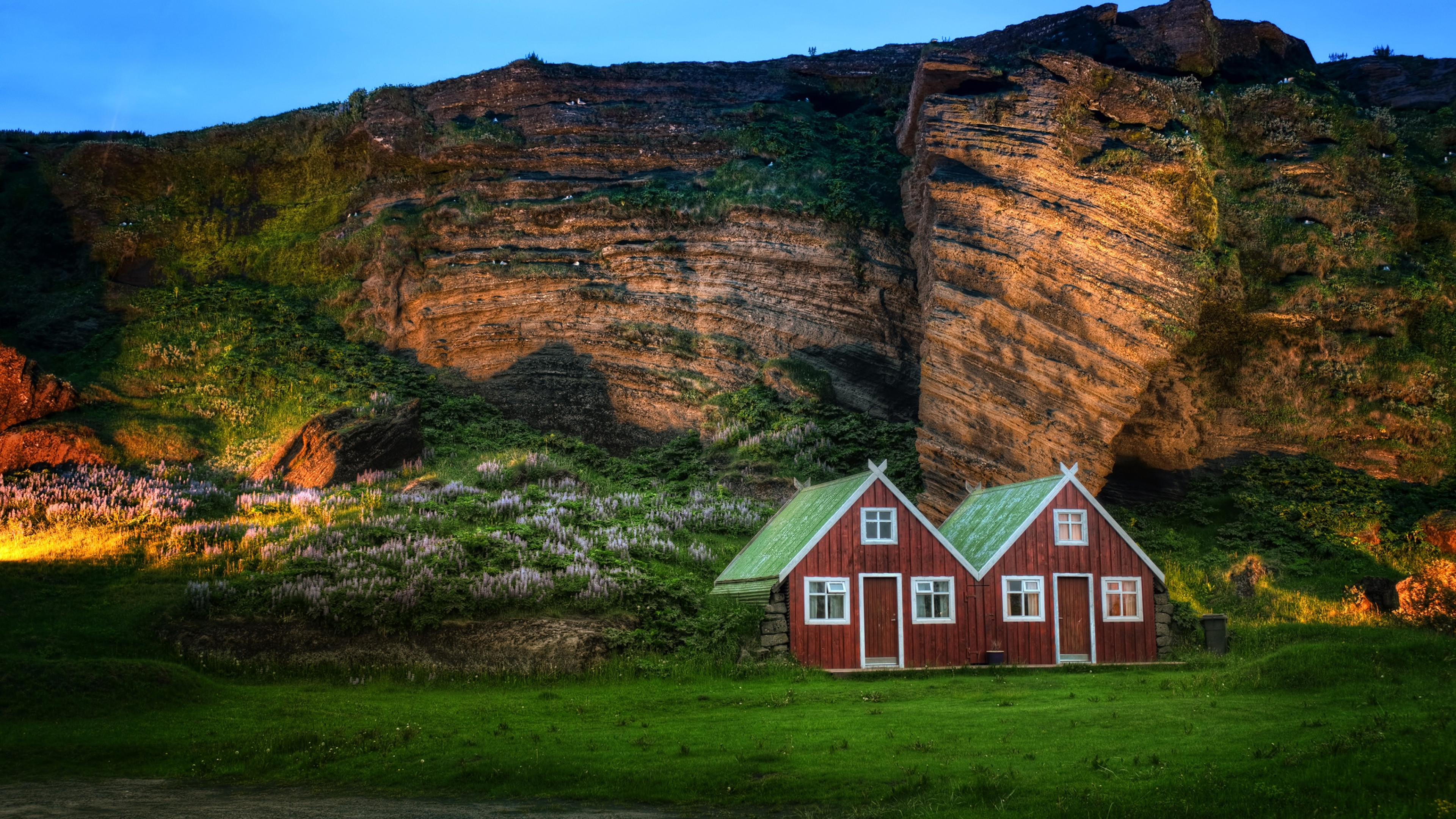 3840x2160 Preview wallpaper iceland, mountain, rock, lodges, light, meadow 