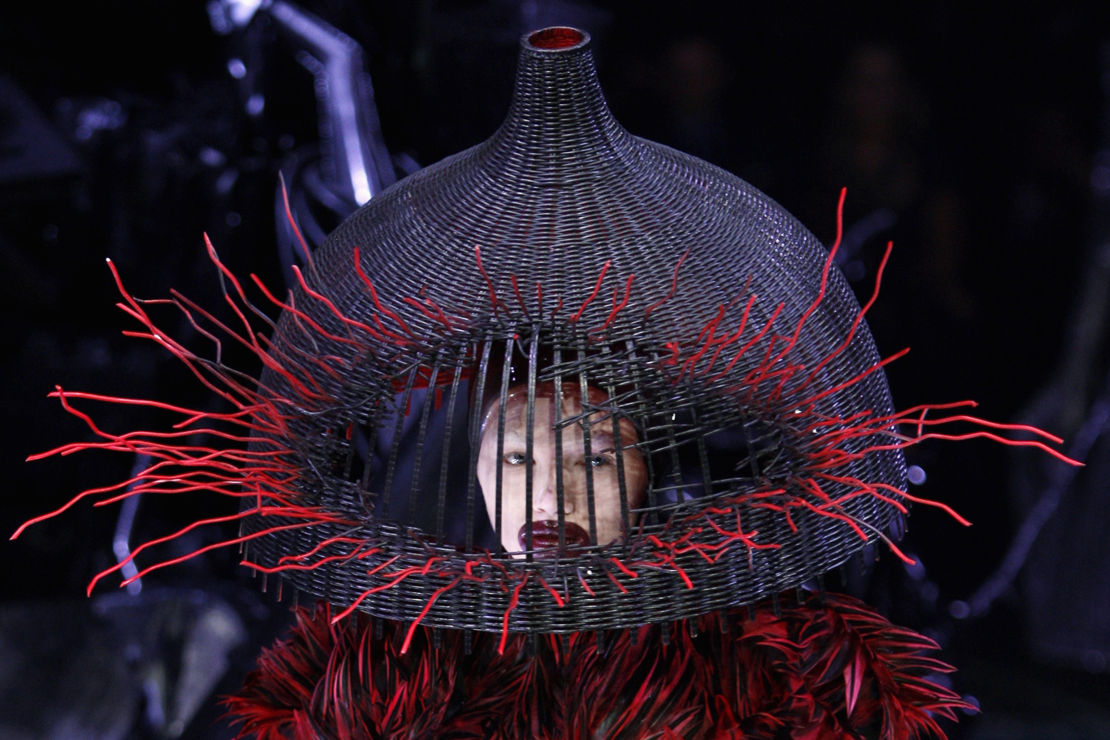 2200x1467 A model wears a demented woven basket on her head by British designer Alexander  McQueen as