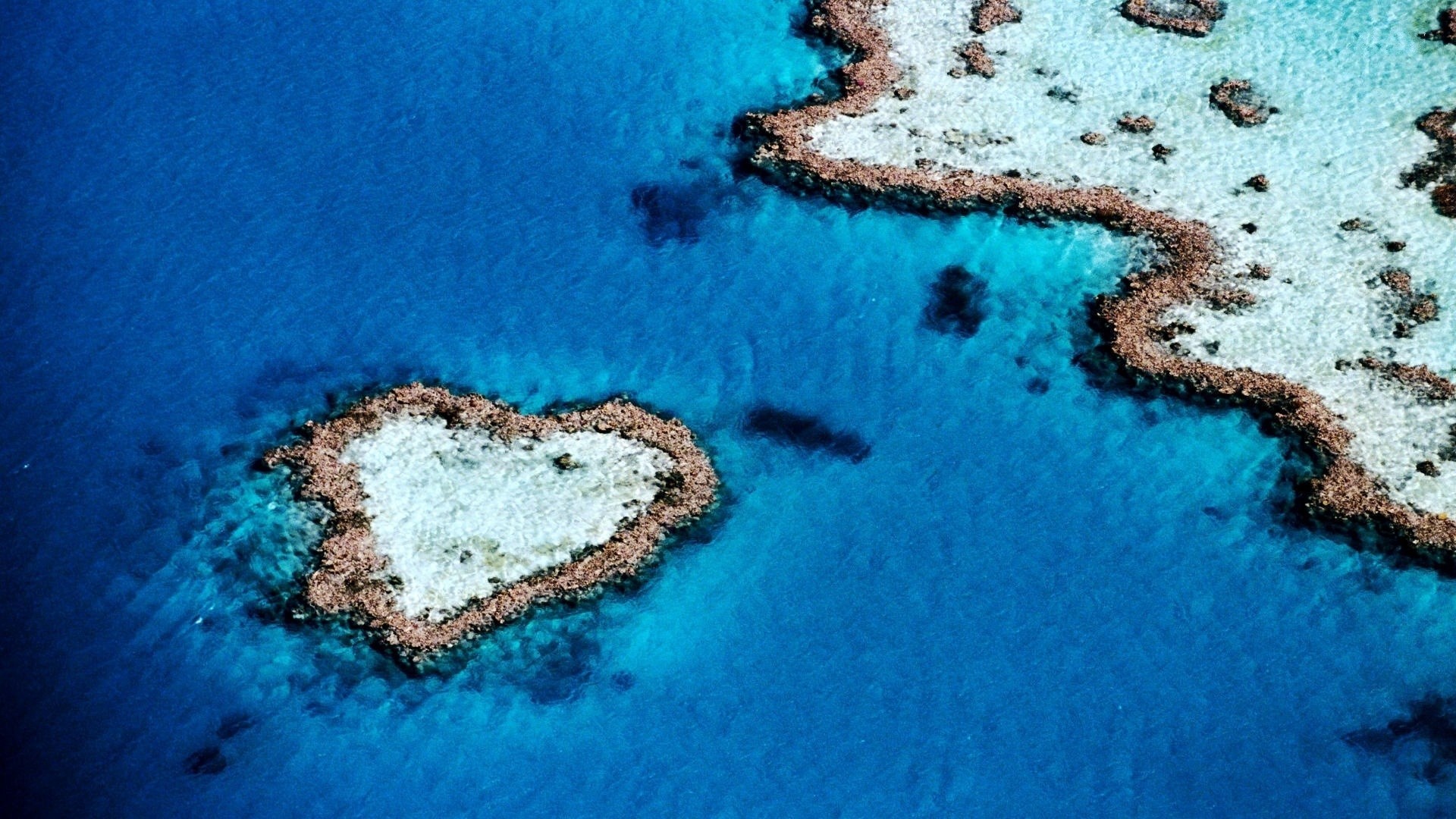 1920x1080  Wallpaper sea, island, ocean, blue water, reeves, heart, land