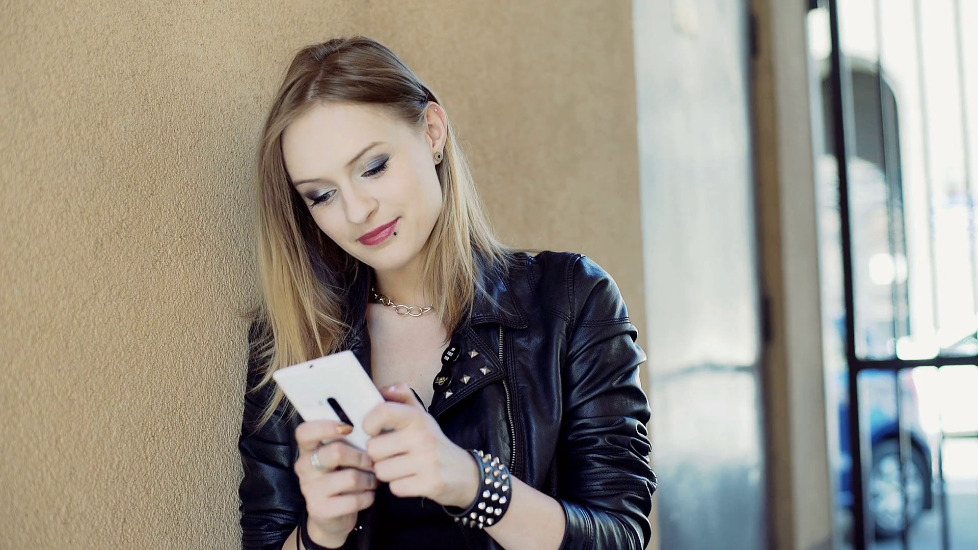 1920x1080 Punk girl texting on smartphone while leaning on the wall Stock Video  Footage - VideoBlocks