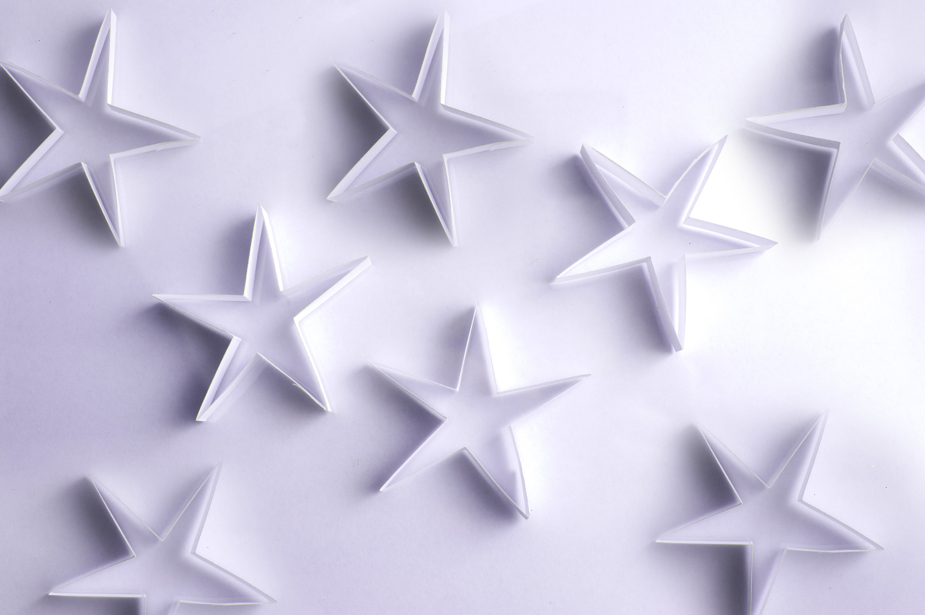 3000x1996 Scattered paper stars on a white background form a lovely delicate backdrop  for your Christmas message