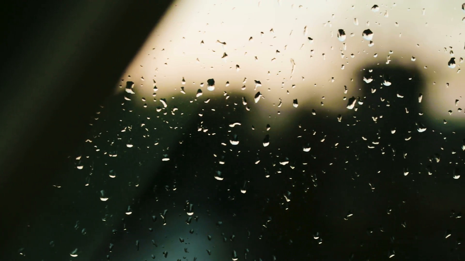 1920x1080 Closeup footage of rain drops on a window with city buildings outlines in  the background. Dolly move. Stock Video Footage - VideoBlocks