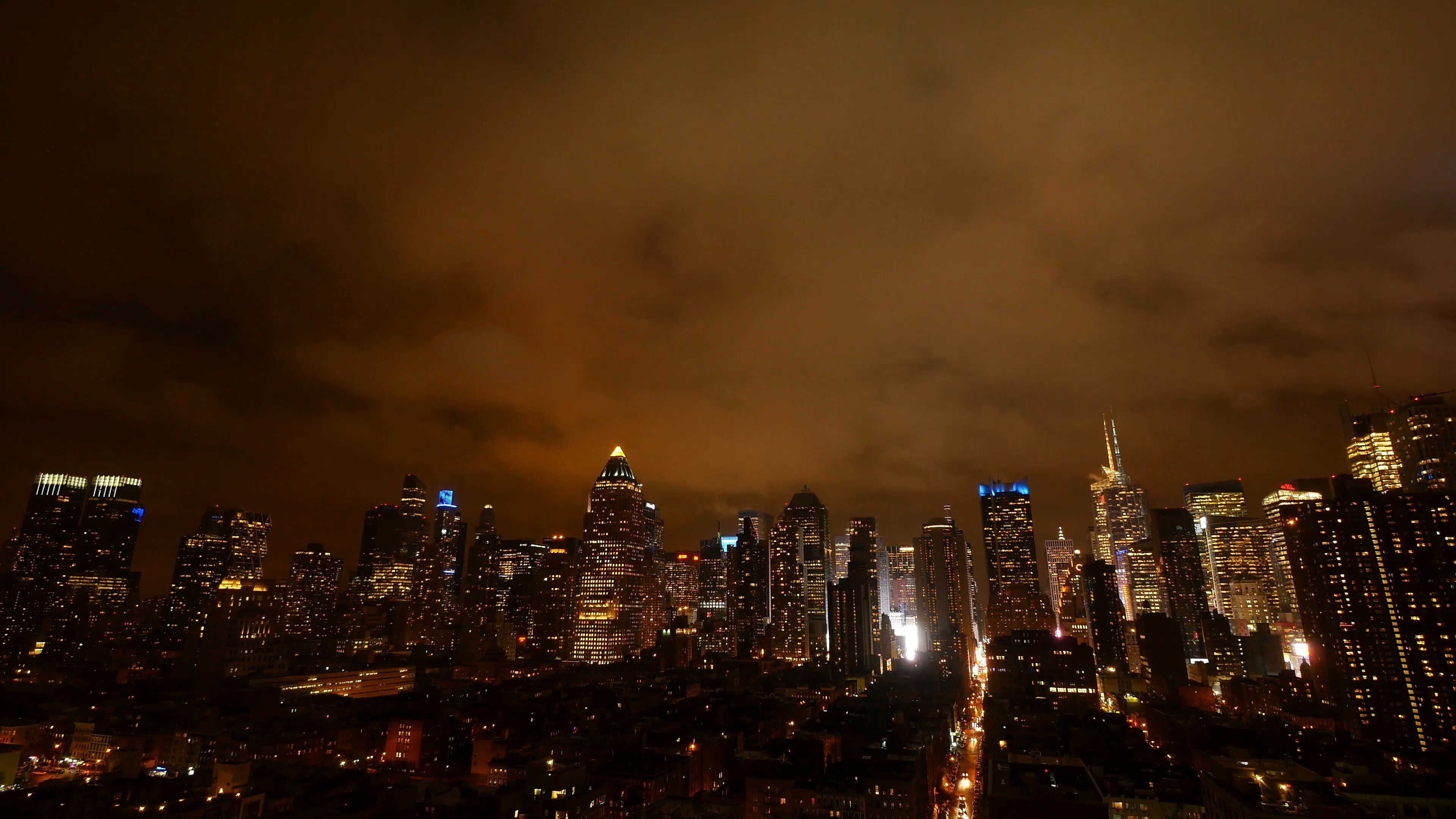 3840x2160 clouds moving over city skyline at night sky. urban building lights  background