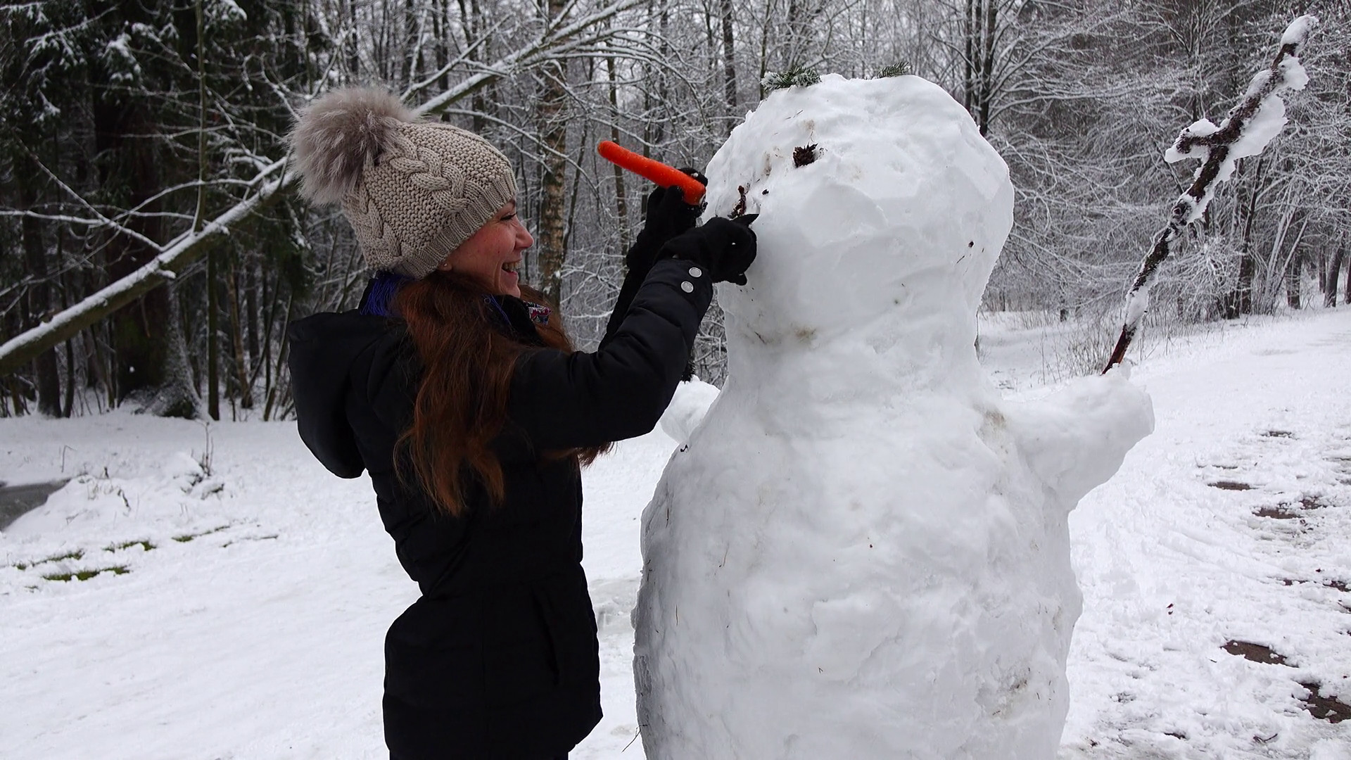 1920x1080 Funny winter scene, woman try to make snowman nose using carrot Stock Video  Footage - VideoBlocks