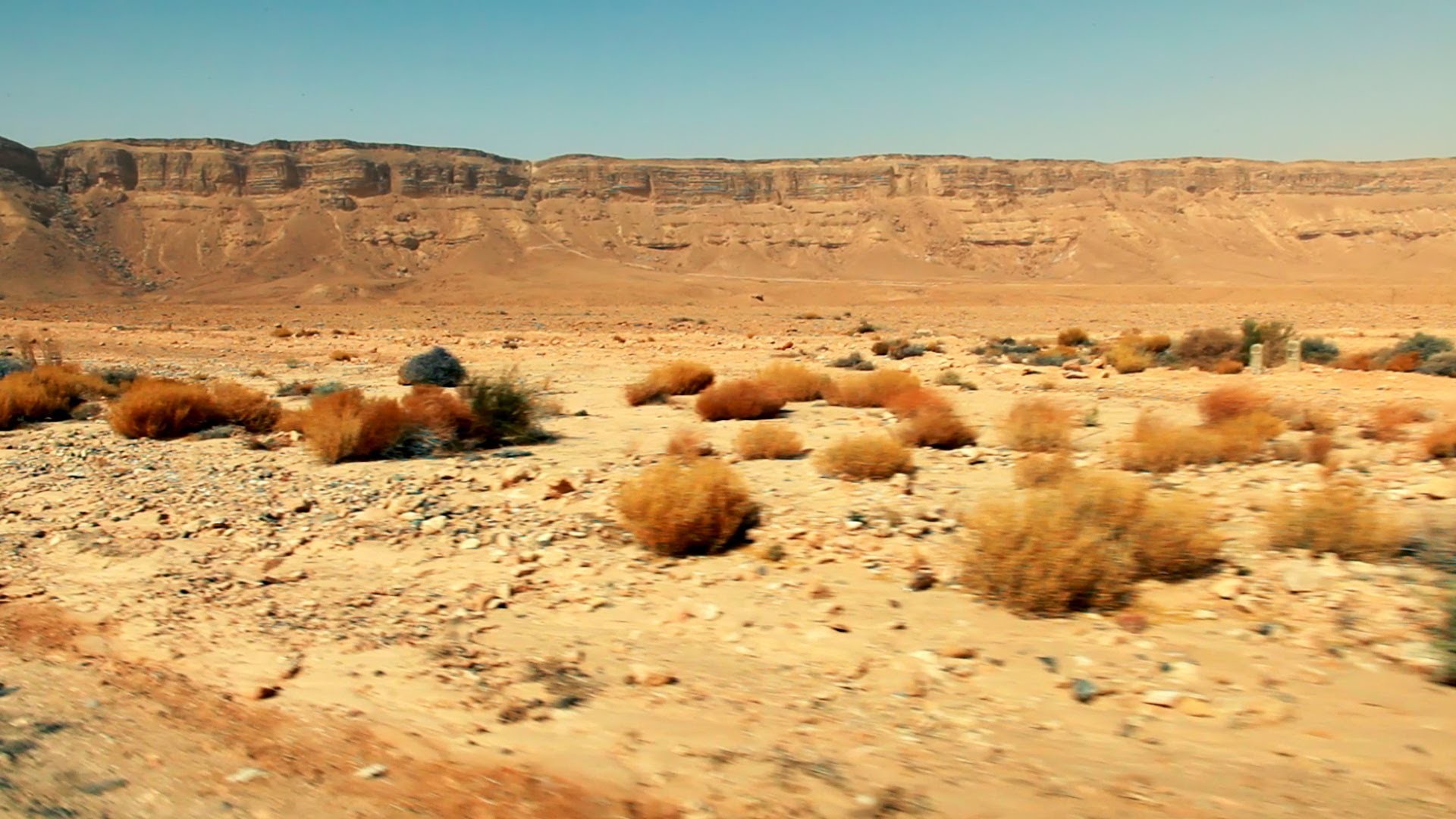 1920x1080 Stock Footage drive-by of the Makhtesh Ramon desert floor in Israel.