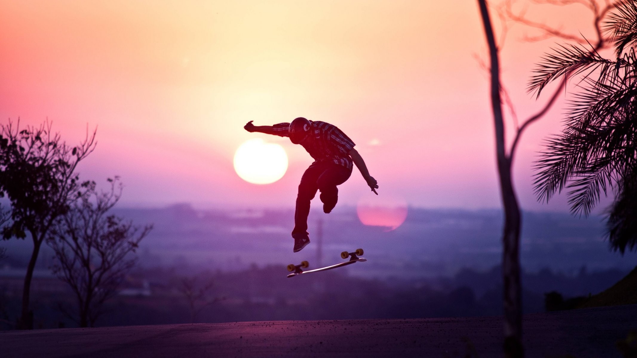 2133x1200 guy helmet skateboard jump sun sunset