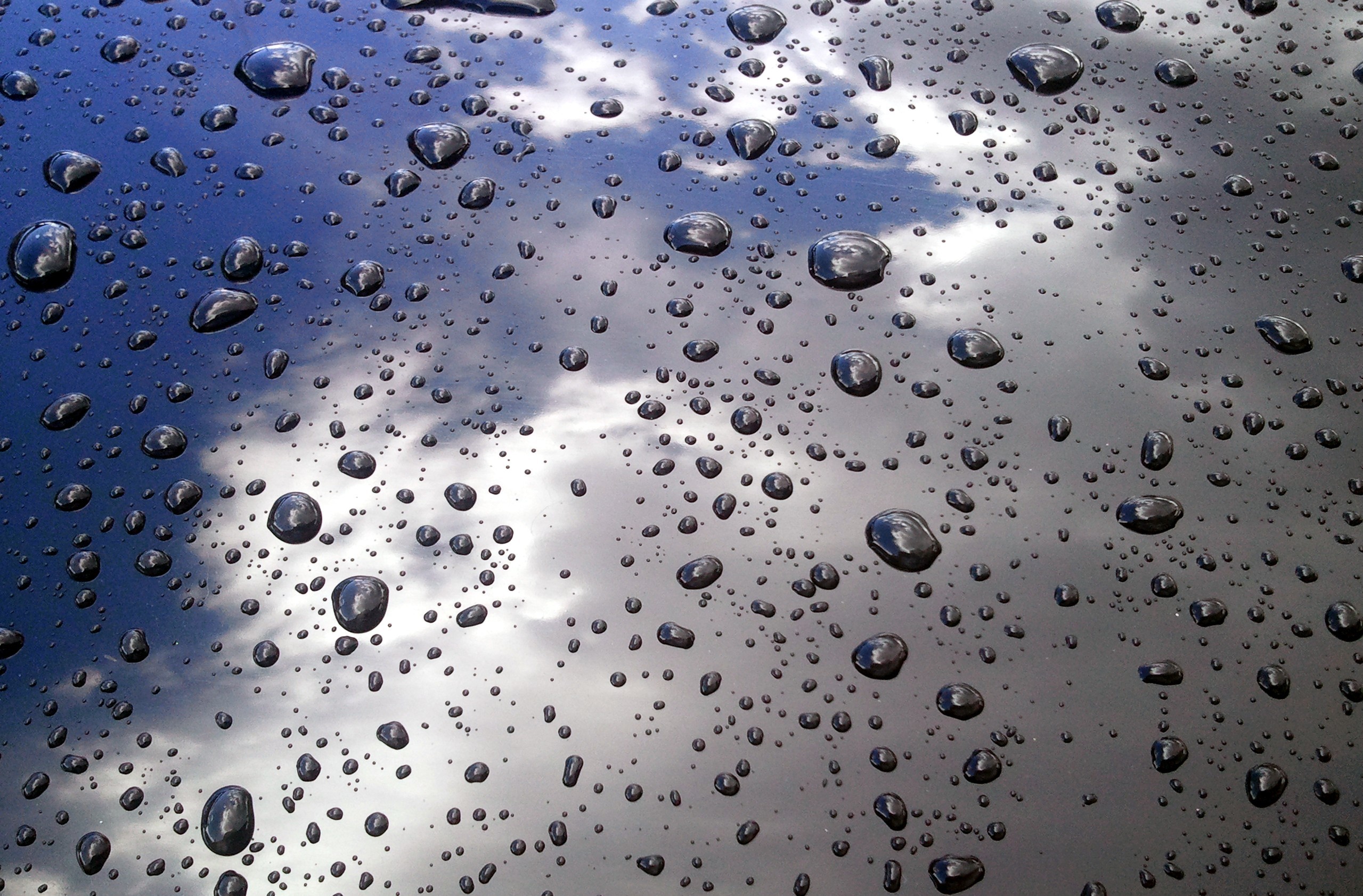 2559x1683 Picture of rain drops on a car
