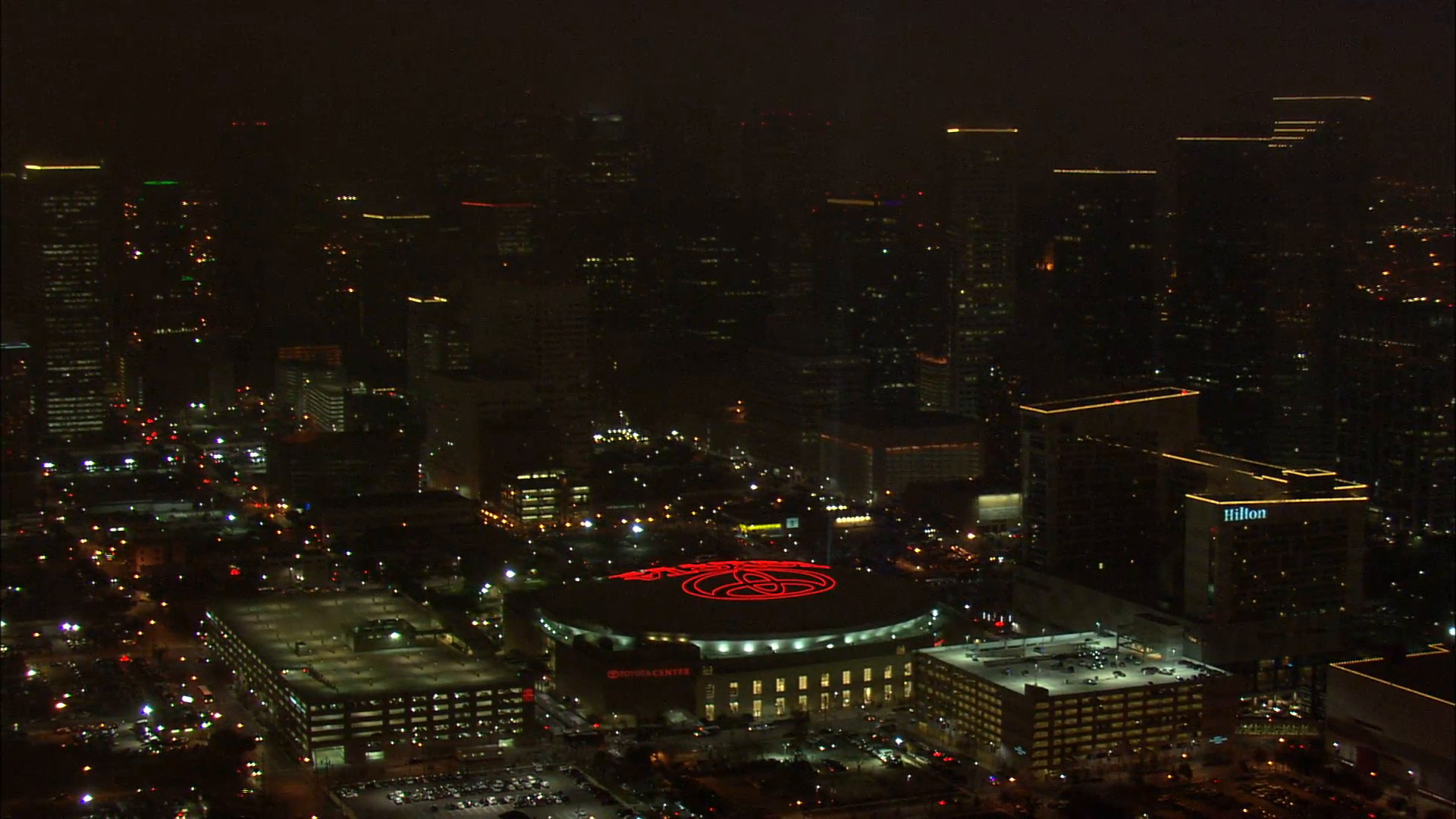 1920x1080 Houston Skyline Nighttime. A beautiful aerial view of the Houston skyline at  night. Towering buildings light up the background with the Toyota Center at  the ...