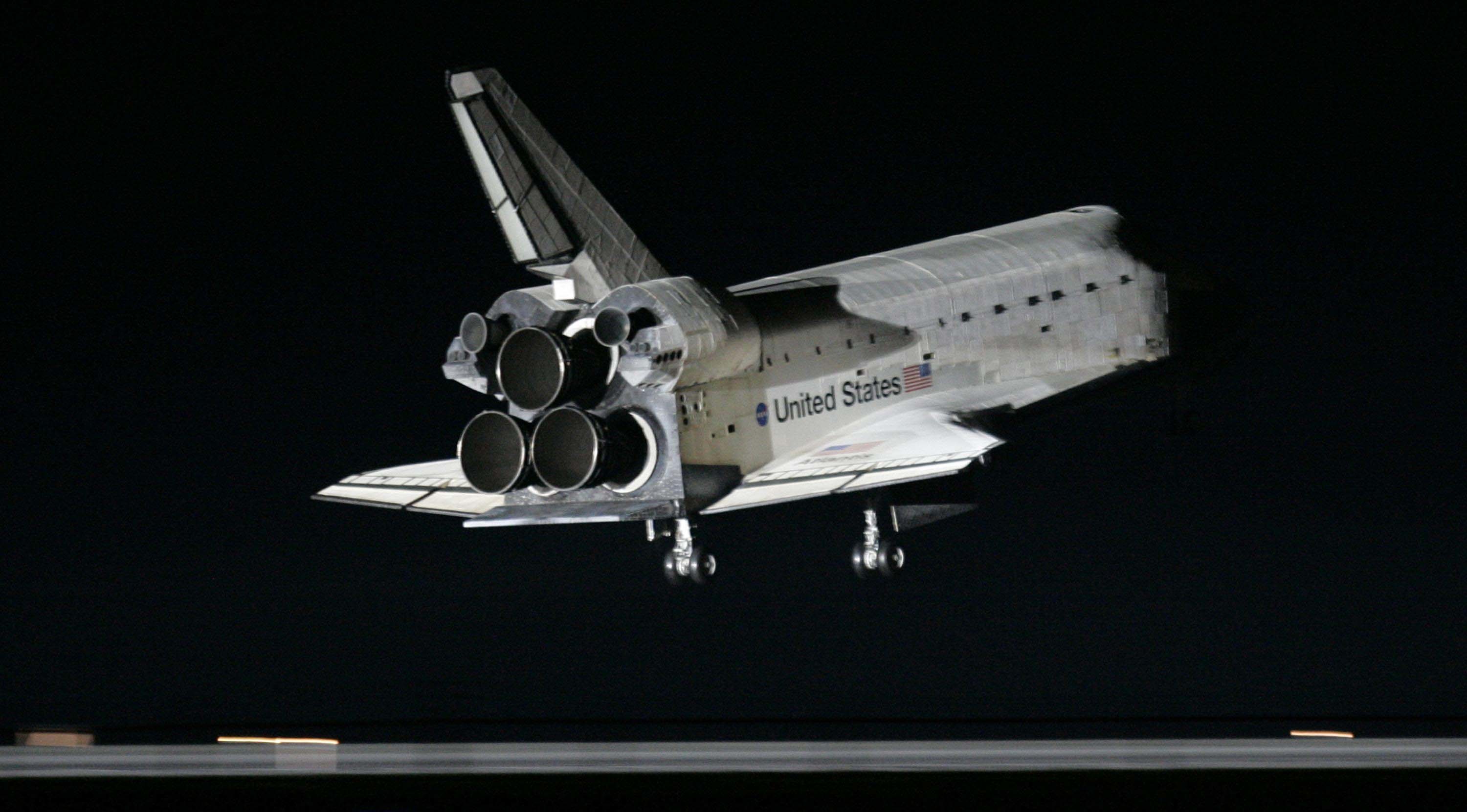 3000x1661 Shuttle Atlantis just about to touch down on runway at night