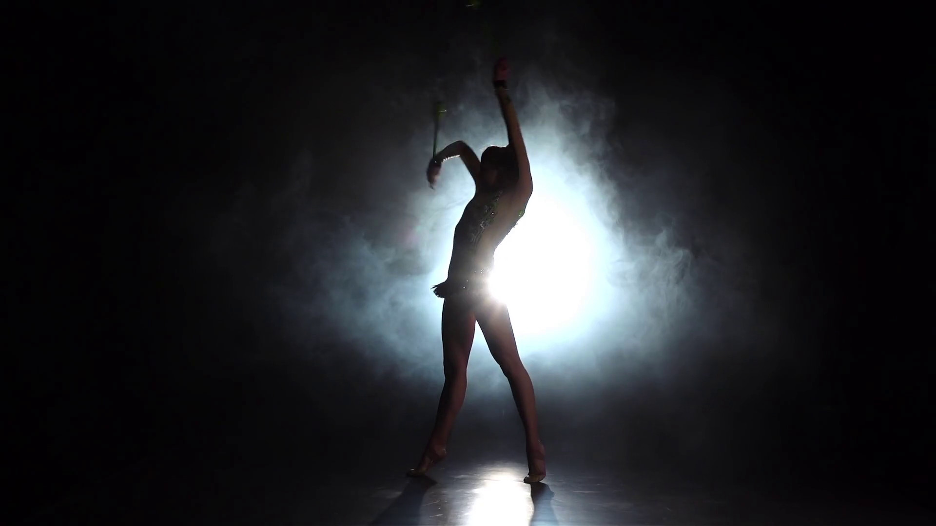 1920x1080 Girl gymnast with mace in hand revolve around him. Black background. Light  rear. Silhouette. Slow motion Stock Video Footage - Storyblocks Video