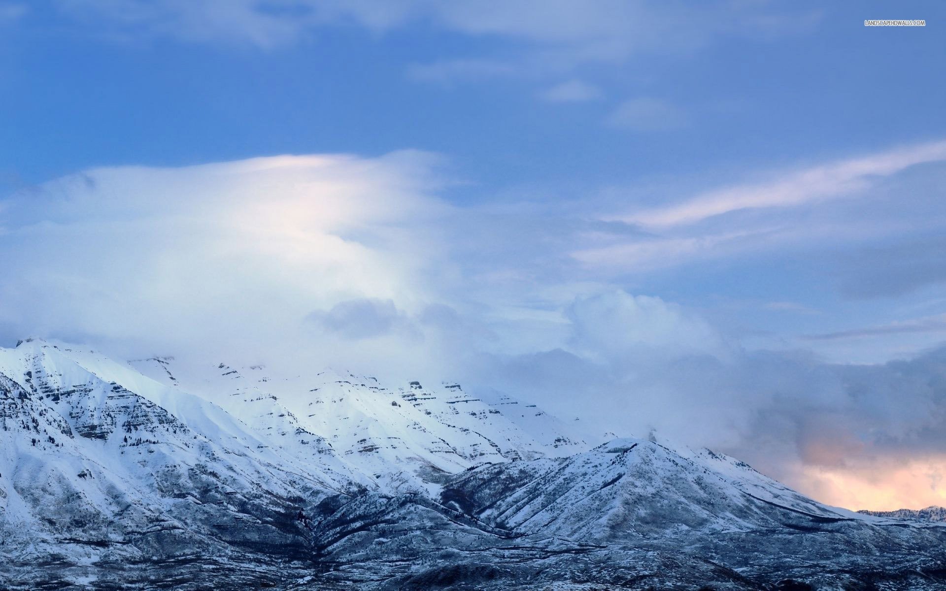 1920x1200 Snowy Mountain Tops Between The Clouds Wallpaper - WallDevil