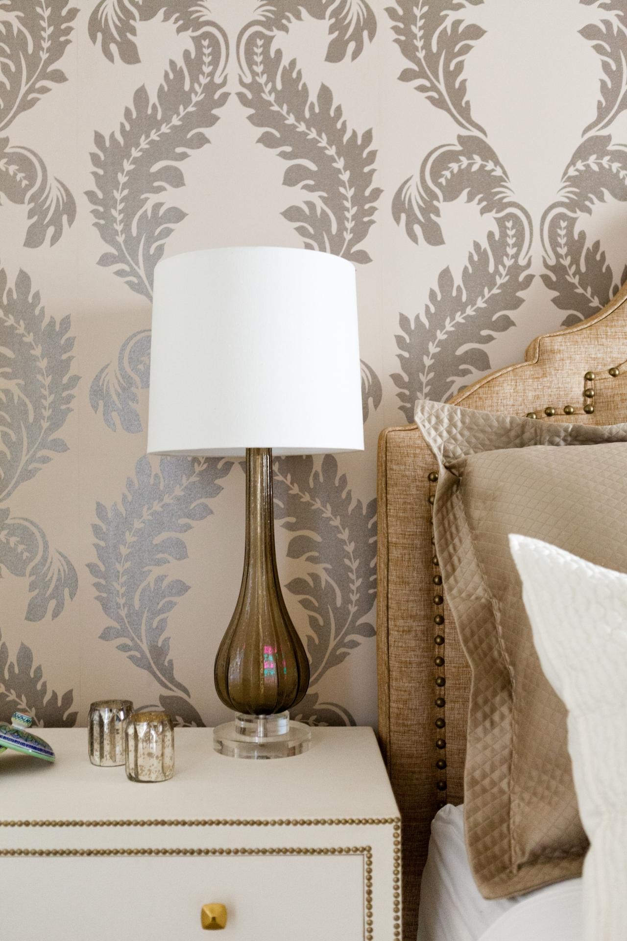 1280x1920 Off-white End Table with Blown-glass Lamp near Upholstered Headboard and  Metallic-printed Wallpaper