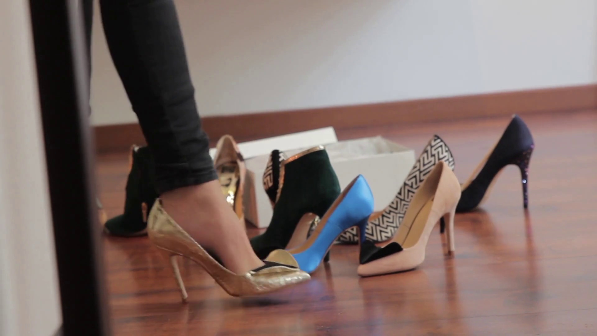 1920x1080 Woman walking on golden high-heeled shoes in front of mirror in shoe shop  with other high heels on the background Stock Video Footage - VideoBlocks