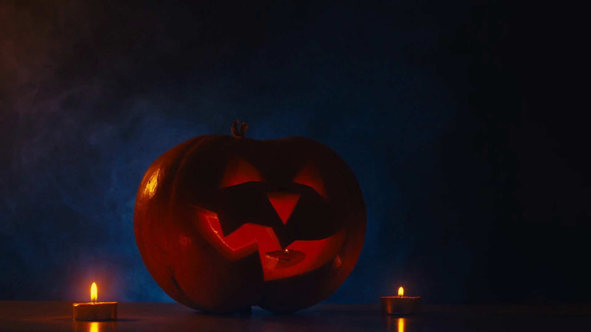 1920x1080 CINEMAGRAPH - CU Halloween carved pumpkin Jack-o-Lantern with candles, fog  in the background. Motion photo seamless loop Stock Video Footage -  Storyblocks ...