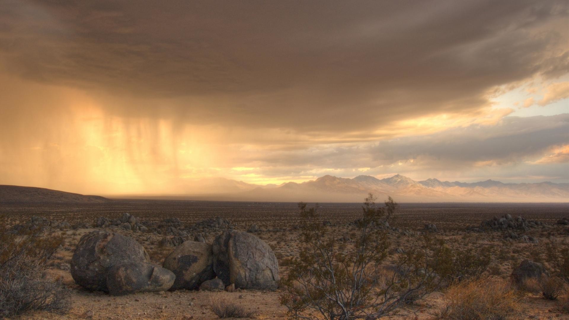 1920x1080 Rain clouds wallpaper moving across a desert.