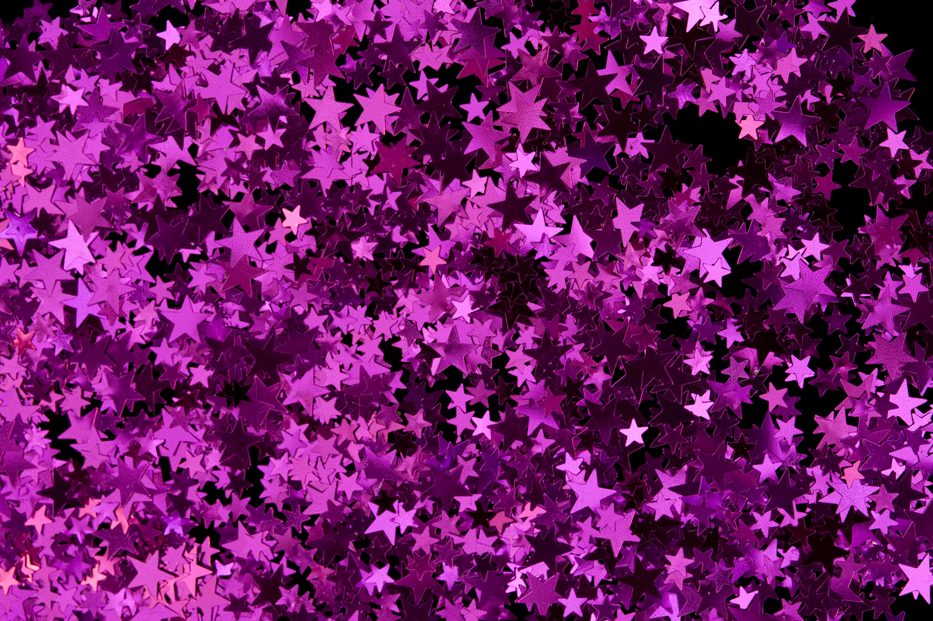 3000x1996 a colorful reflective backdrop of magenta pink metallic confetti stars