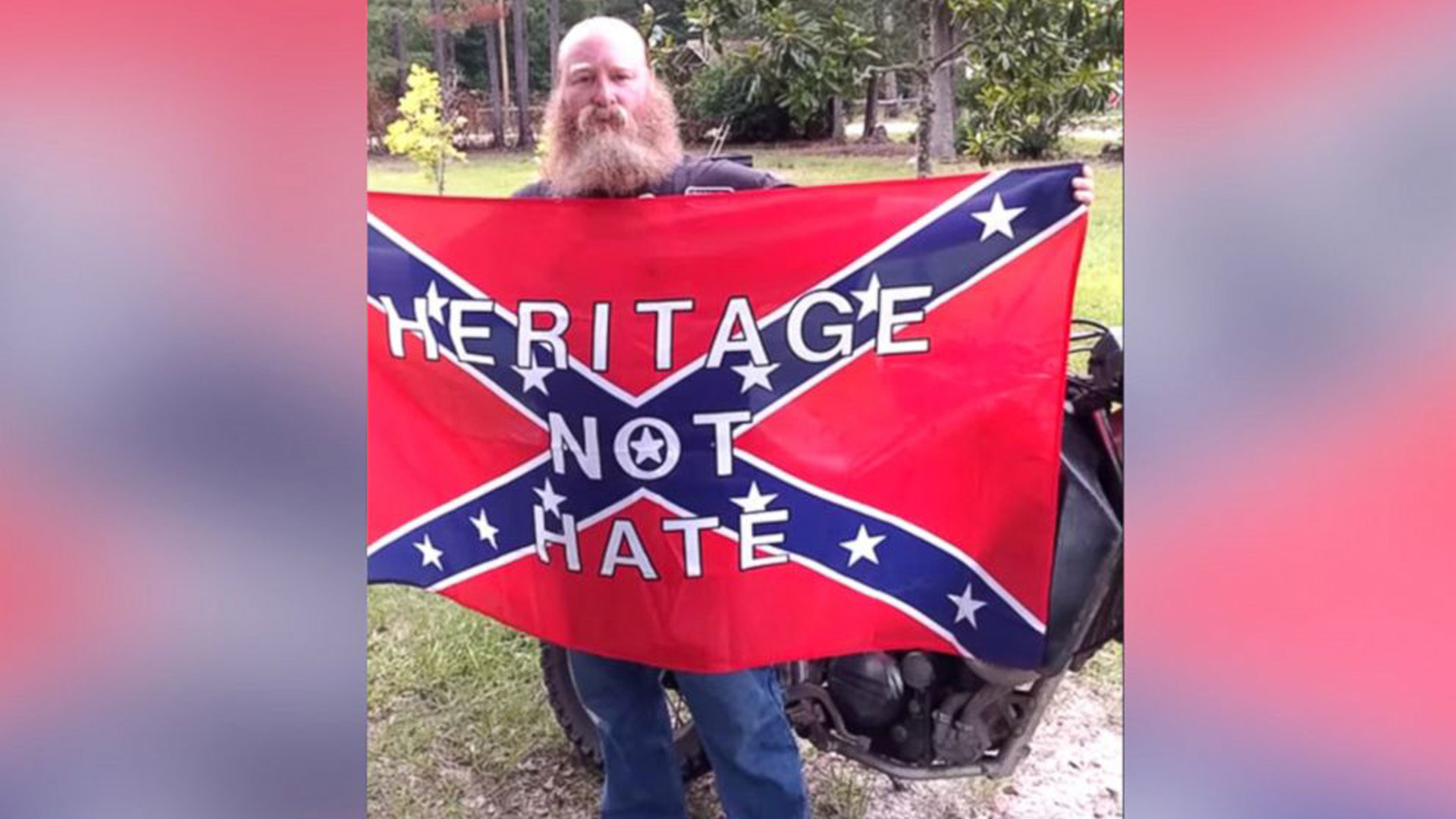 1920x1080 PHOTO: Chuck Netzhammer holding a Confederate flag with the words Heritage  not Hate on it