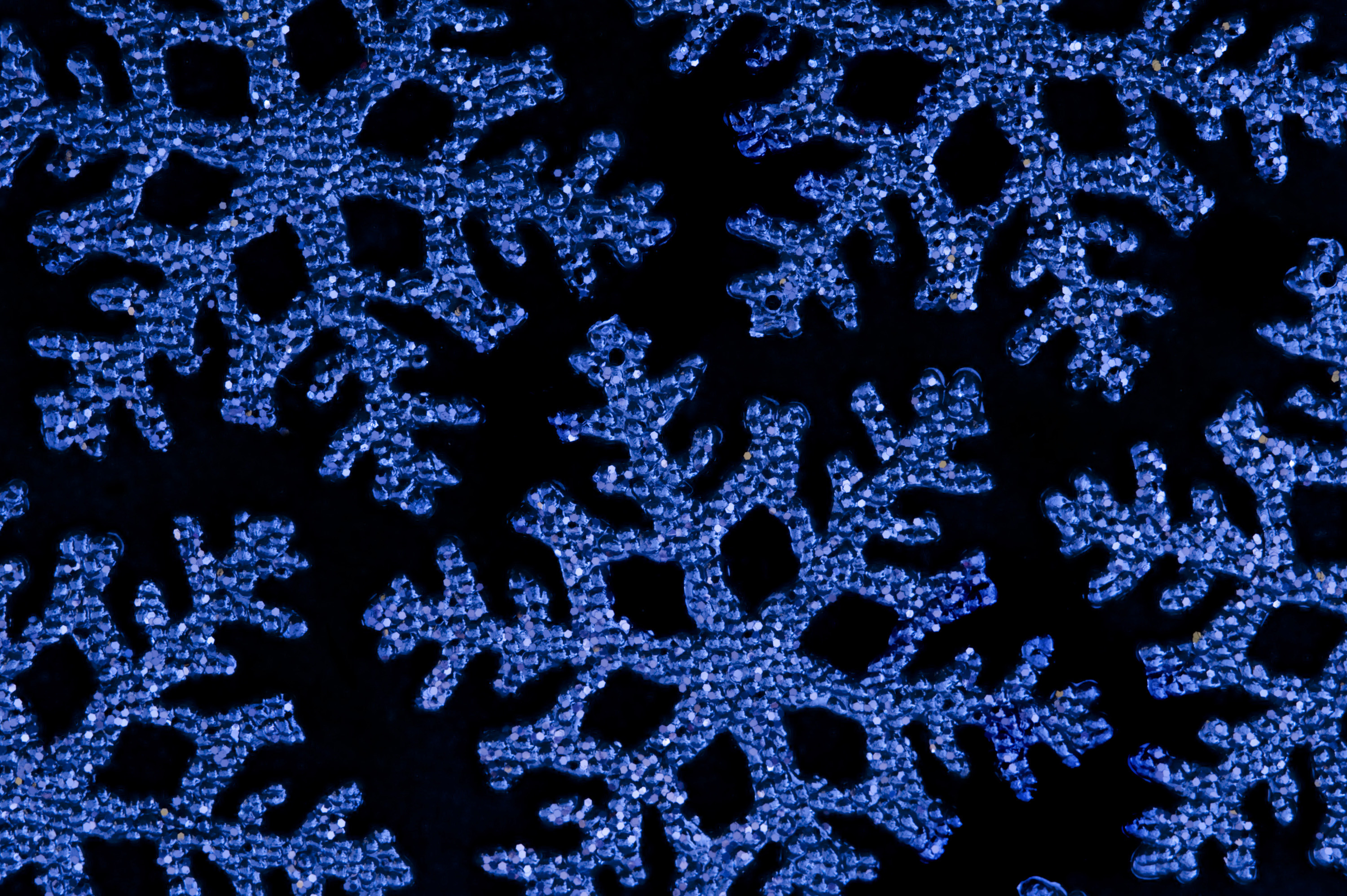 3000x1996 blue christmas snowflake shape decorations on a black backdrop